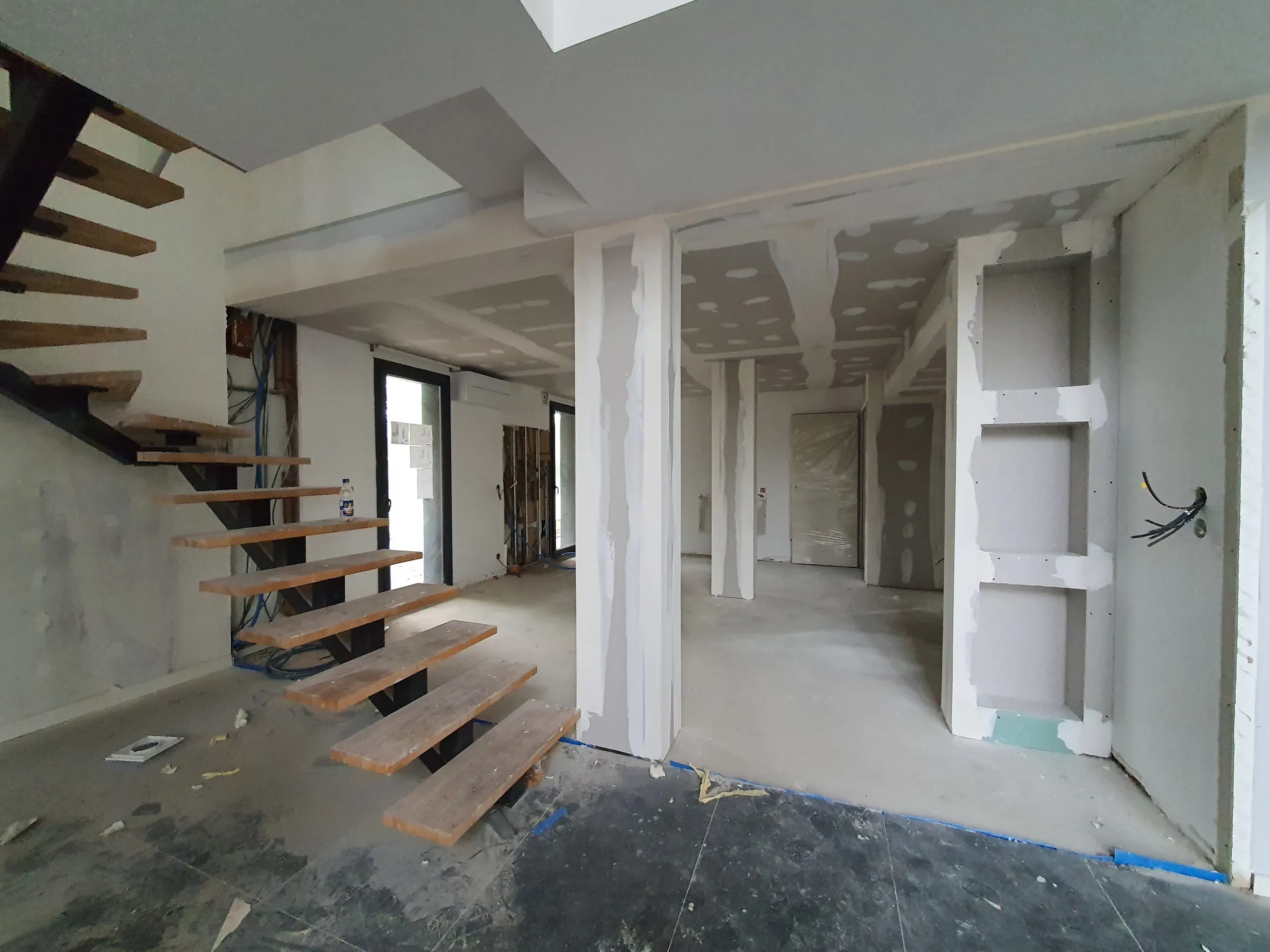 Escalier en bois et cloisons en plaques de plâtre pendant le chantier du projet Lyre